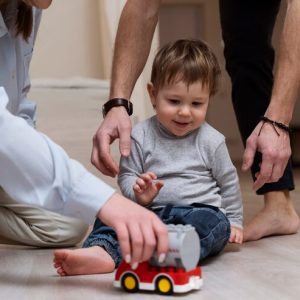 parents-kid-with-toy-home_23-2149307053
